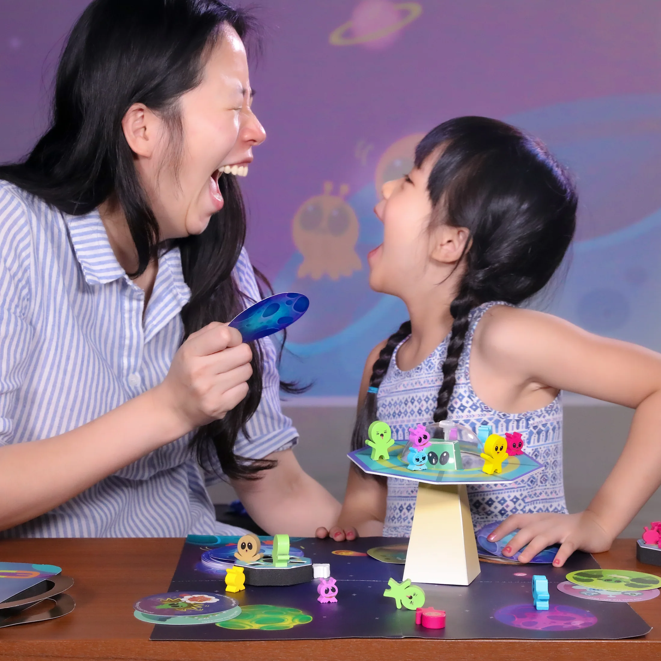 A mother and child playing AHA! Tantrum together