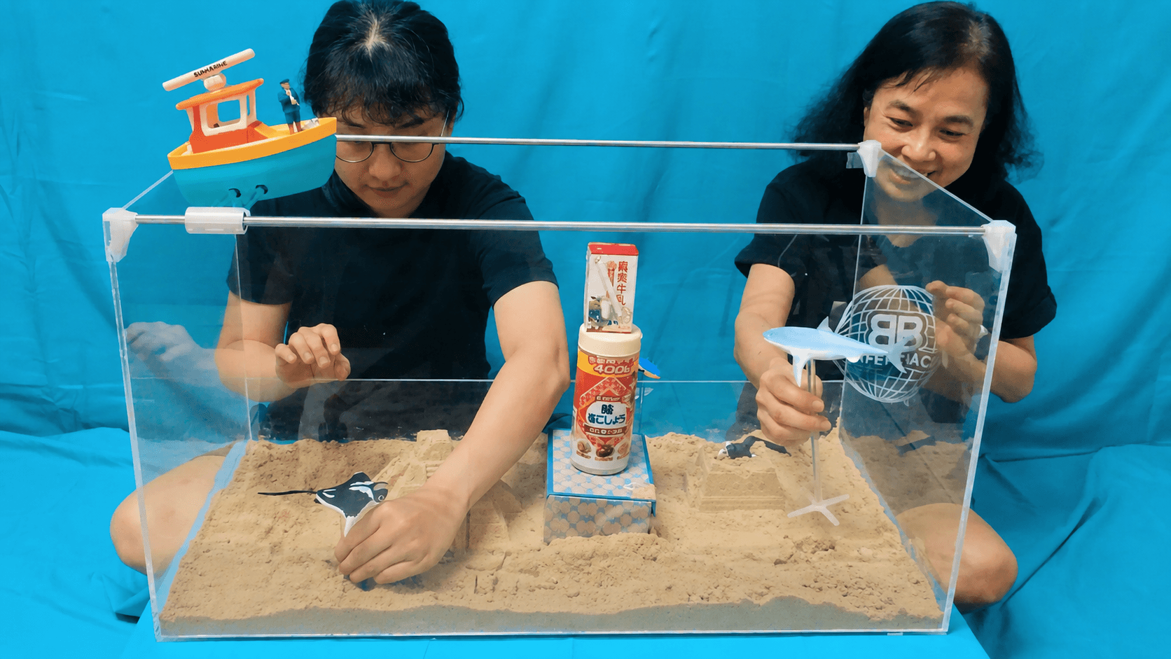 Players shaping terrain and placing marine creatures in a physical underwater world